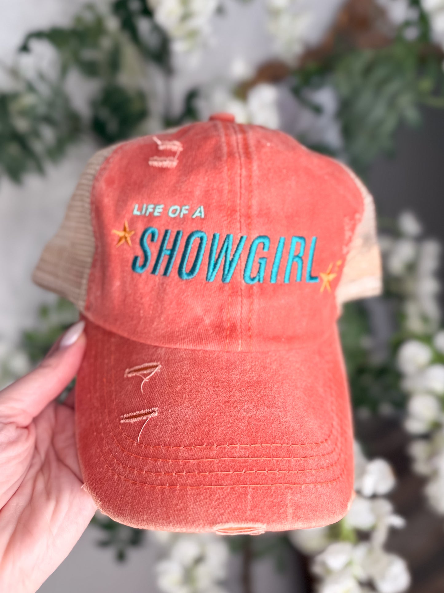 Life of a showgirl orange hat
